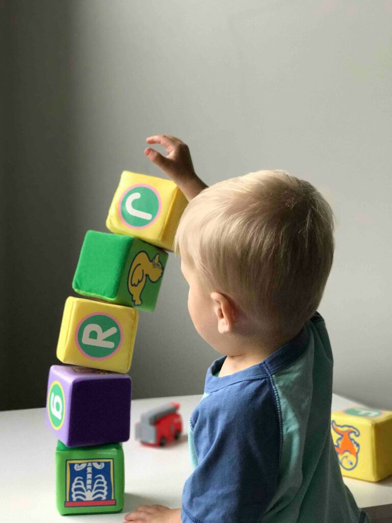 boy stacking blocks